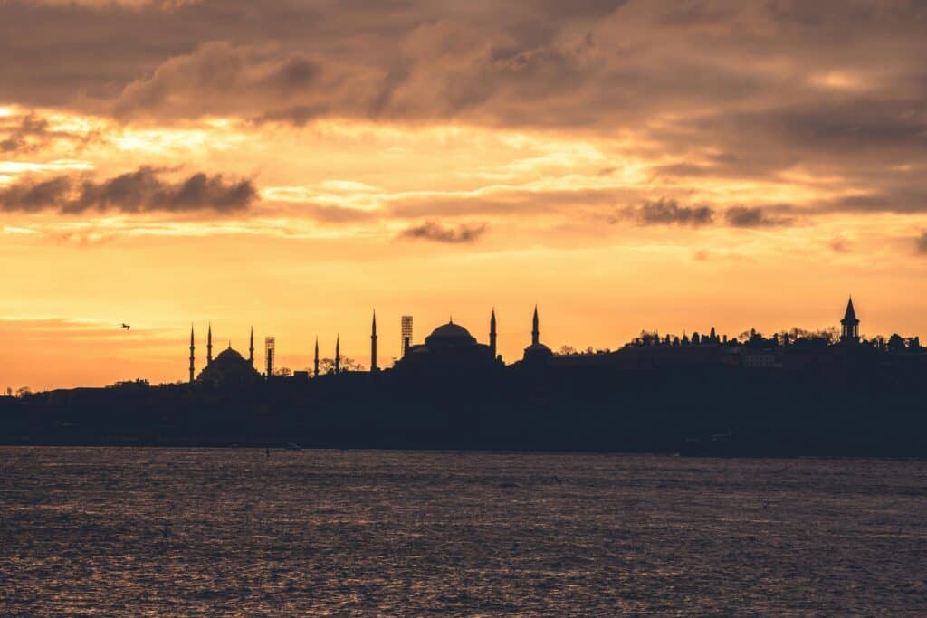 Stunning silhouette of Istanbul's skyline during a golden sunset, capturing the city's iconic skyline over the water.